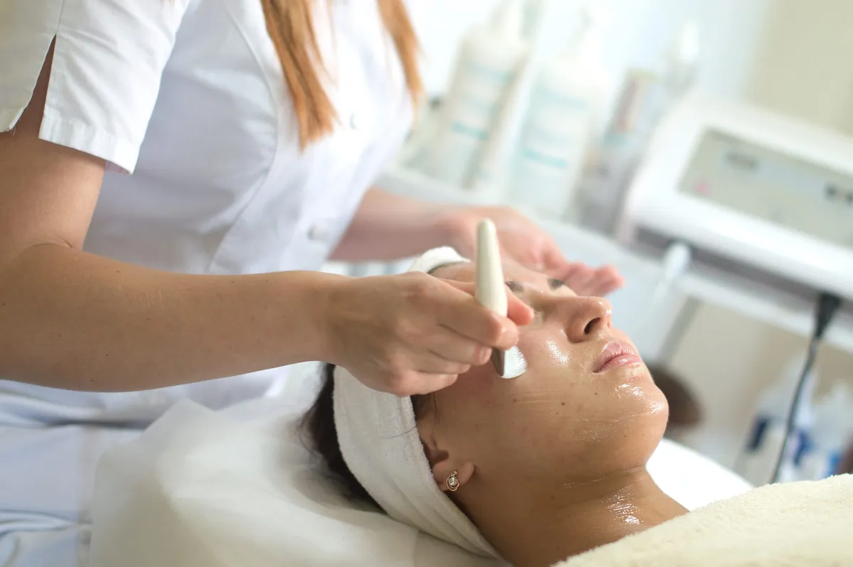 Woman receiving a facial skin rejuvenation treatment — SOS Aesthetics